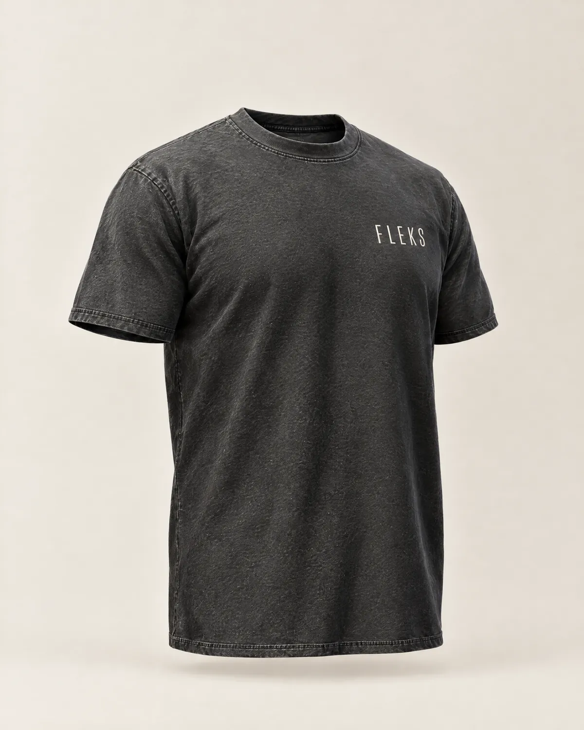 Studio render of FLEKS Tee 01 in faded black: cut like an XL across the chest, a longer body, and short sleeves that sit close on the bicep